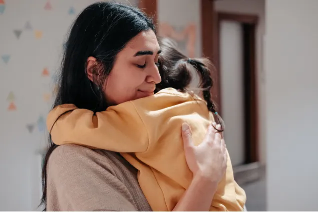 Mother hugging child